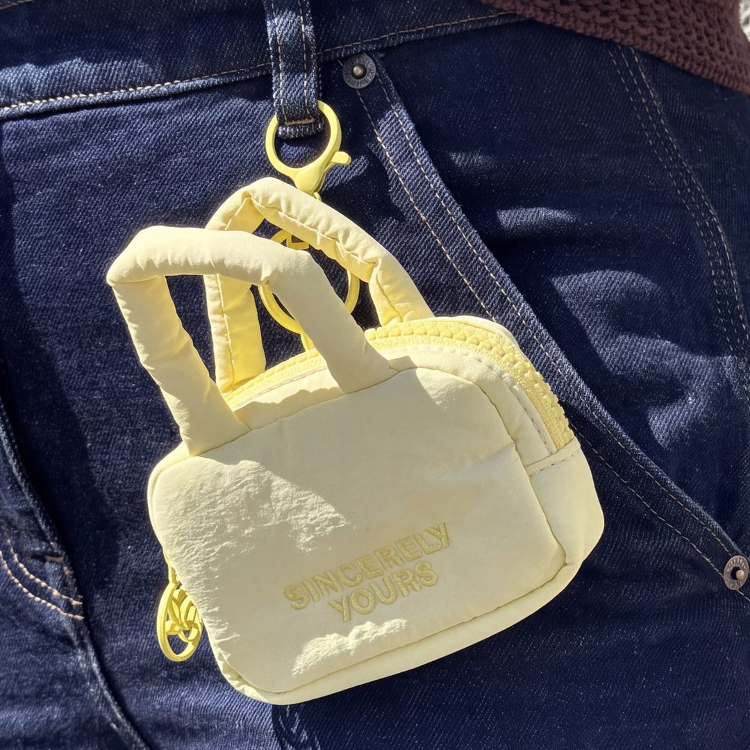 The mini cloud case keychain clipped to a belt loop