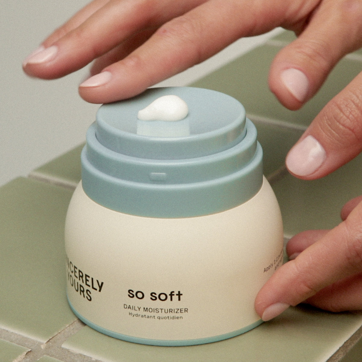 50 ml | 30 ml | Hand applying cream from a jar labeled 'So Soft' on a tiled surface