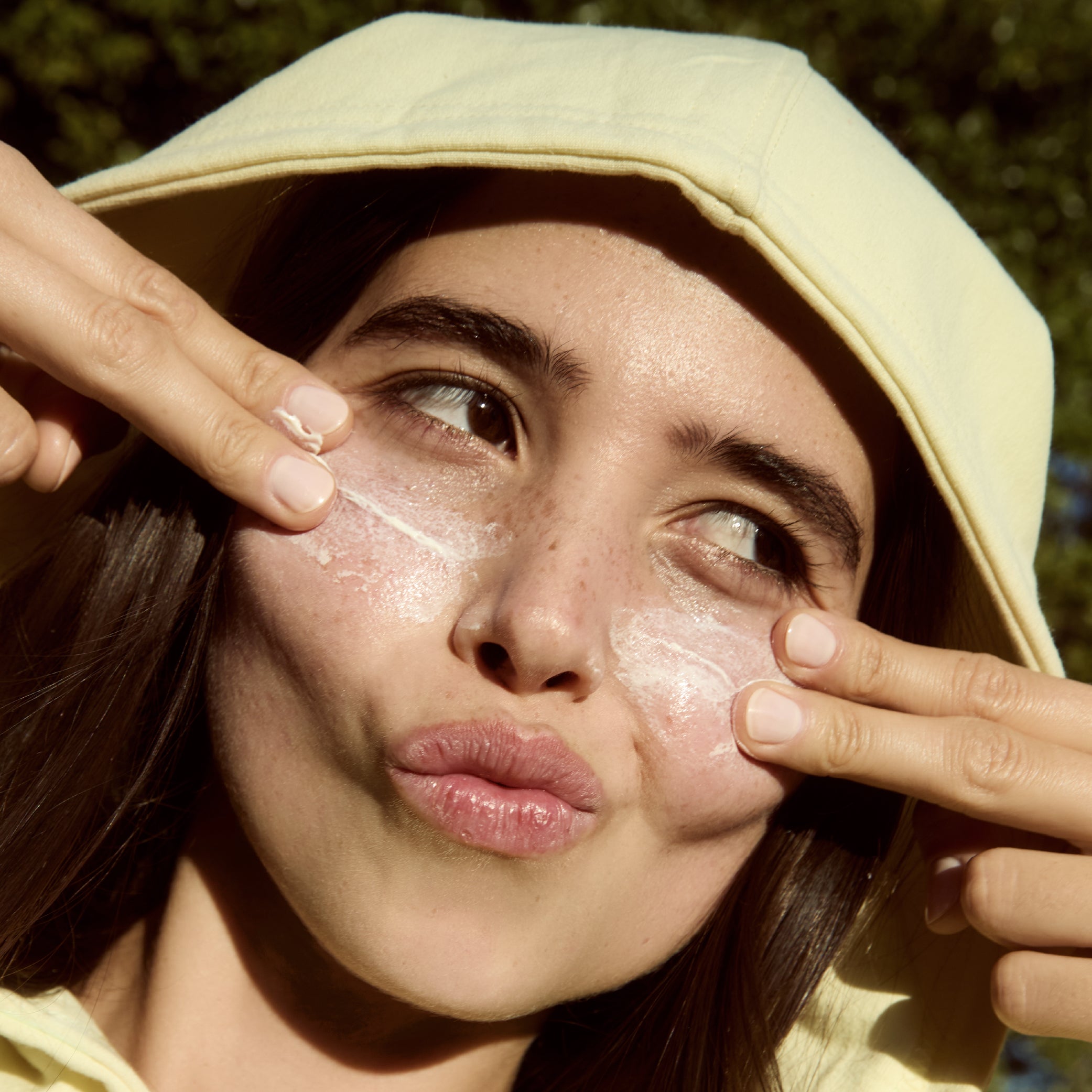 50 ml | Person applying Sunny Side Up sunscreen to their face outdoors