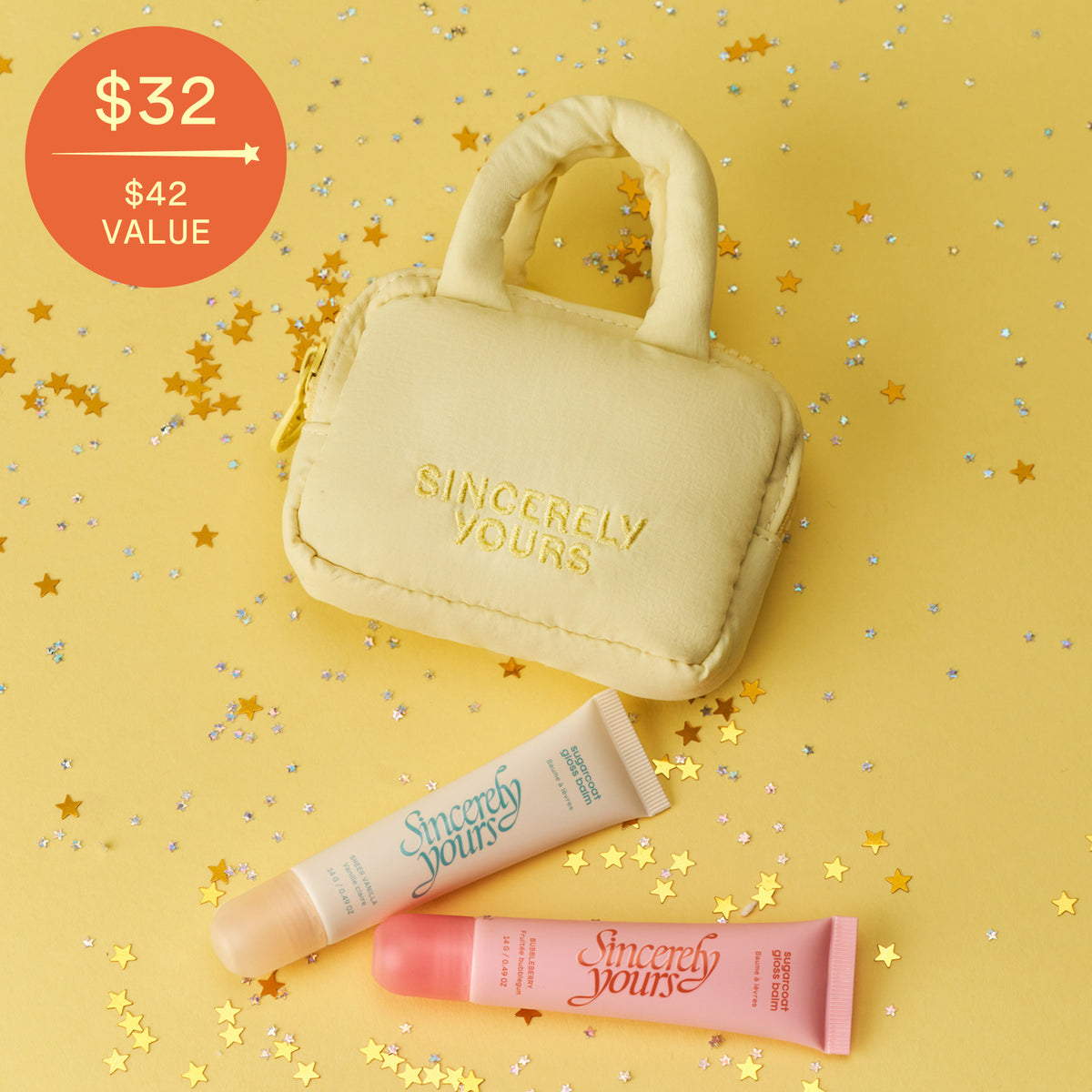 The Gloss To Go Set keychain and gloss balms on gold star confetti