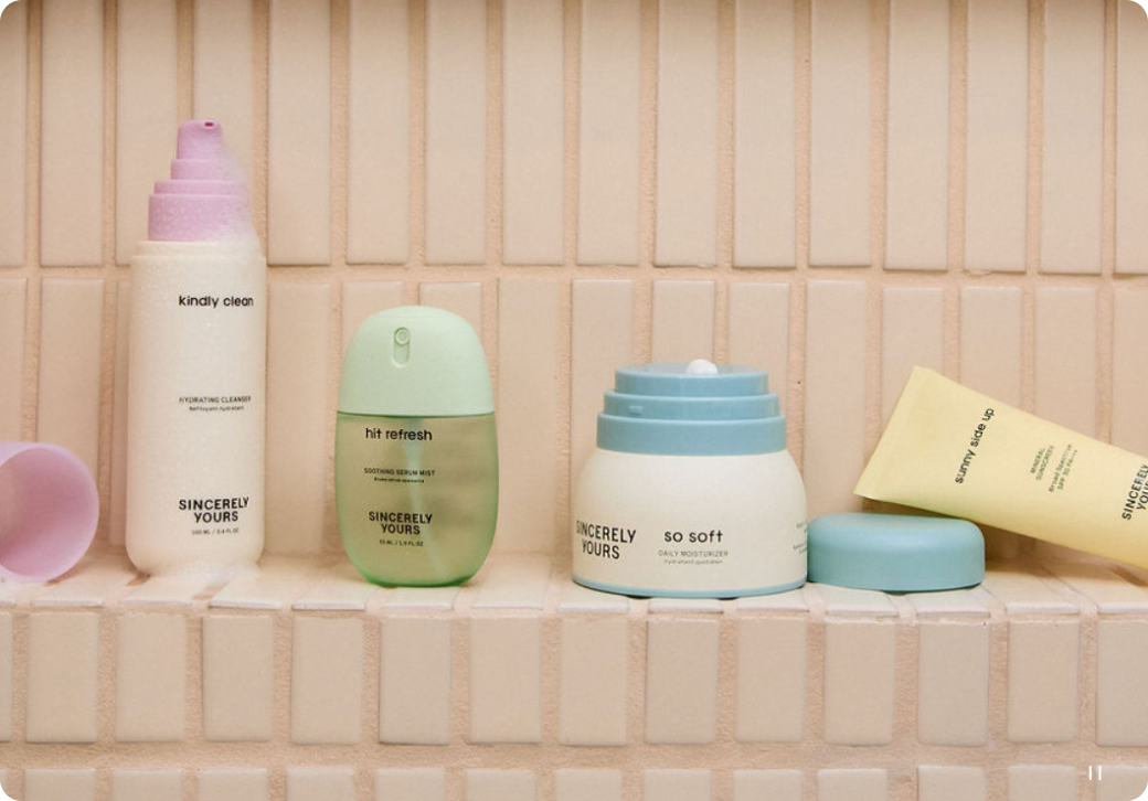 Collection of skincare products on a tiled bathroom shelf